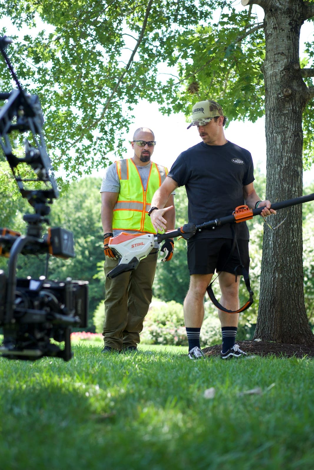 A director talking a demonstrator through a take with a trimmer, gimbal rig framing them from the left